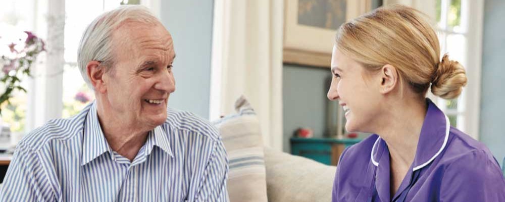 happy daughter visiting her smiling father who is at the Vilas Home for memory care services